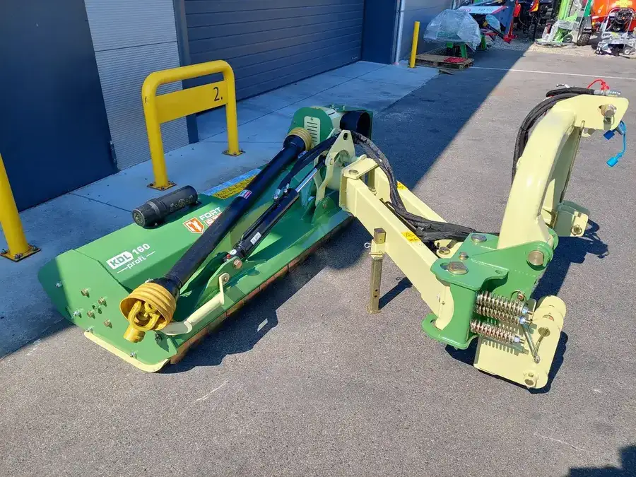 Zielona kosiarka bijakowa STARK KDL Profi z ramieniem hydraulicznym.